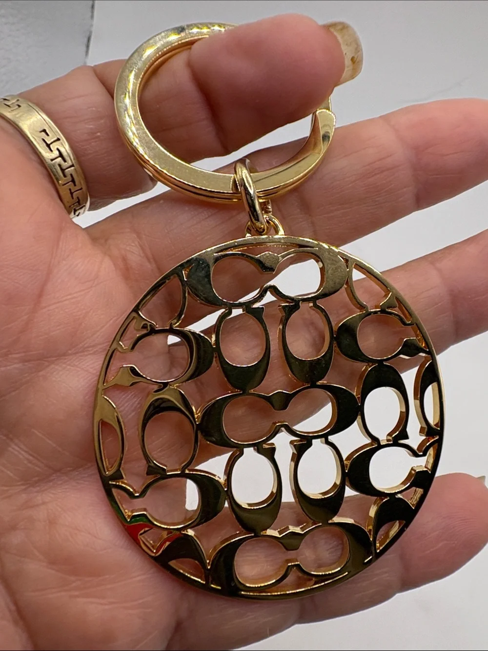 Coach Gold Logo Cutout Circle Keychain